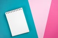 Notebook on trendy turquoise, pink, magenta paper colorful background. Workspace, study concept.