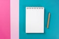 Notebook on trendy turquoise, pink, magenta paper colorful background. Workspace, study concept.