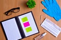 Notebook with vacuum tubes for blood collection and rubber gloves on a wooden table Royalty Free Stock Photo