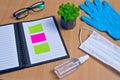 Notebook with vacuum tubes for blood collection and rubber gloves on a wooden table Royalty Free Stock Photo