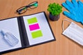 Notebook with vacuum tubes for blood collection and rubber gloves on a wooden table Royalty Free Stock Photo