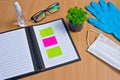 Notebook with vacuum tubes for blood collection and rubber gloves on a wooden table Royalty Free Stock Photo