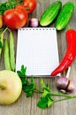 Notebook with vegetables and pepper