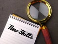 vintage magnifying glass with the word New Skills. Royalty Free Stock Photo