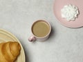 The notebook, wooden pencil and sharpener, cup of coffee, marshmallow on the granite table and white floor