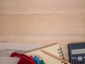 Notebook,wooden pencil,stationary,calculator and mathematics study worksheet on beige wooden background