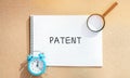 Notebook with the word Patent. Form of intellectual property. Document attesting the right of an inventor to his invention. Alarm