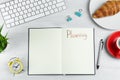 Notebook with word Planning, coffee, alarm clock, computer keyboard, croissant and stationery on white table, flat lay Royalty Free Stock Photo