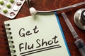 Notebook with the words Get Flu shot. Royalty Free Stock Photo