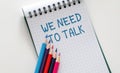 A notebook with the words We Need to Talk written on it Royalty Free Stock Photo