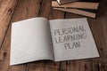 A notebook with the words personal learning plan written on it Royalty Free Stock Photo