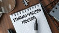 A notebook with the words Standard Operation Procedure written on it. Royalty Free Stock Photo