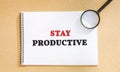 Notebook with the words Stay productive. The concept of motivation and achievement of the set goals. Organization of time. Royalty Free Stock Photo