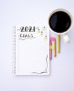 Notebook for writing New Year's resolutions on a table with a coffee cup on the side with colored pencils on the sides Royalty Free Stock Photo