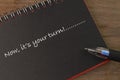 Notebook written with text NOW, IT`S YOUR TURN Royalty Free Stock Photo