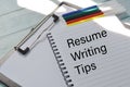 Notebook written with text RESUME WRITING TIPS