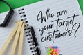 Notebook written with WHO ARE YOUR TARGET CUSTOMERS Royalty Free Stock Photo