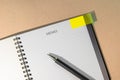 Notebook with yellow page marker note and pen on table. Blank pages for copy space. Reminder concept Royalty Free Stock Photo