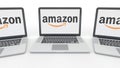 Notebooks with Amazon.com logo on the screen. Computer technology conceptual editorial 3D rendering