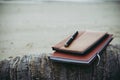 Notebooks,books and pen on the beach.