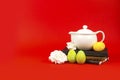 Notebooks, Easter eggs and white tea pot on a red background Royalty Free Stock Photo