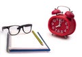 Notebooks , glasses and alarm clock.