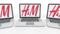 Notebooks with H&M logo on the screen. Computer technology conceptual editorial 3D rendering