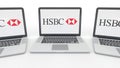 Notebooks with HSBC logo on the screen. Computer technology conceptual editorial 3D rendering