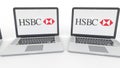 Notebooks with HSBC logo on the screen. Computer technology conceptual editorial 4K clip, seamless loop