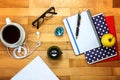Notebooks, pen, glasses, apple on a wooden Royalty Free Stock Photo