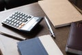 Notebooks, pens and calculator on wood table Royalty Free Stock Photo