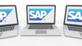 Notebooks with SAP SE logo on the screen. Computer technology conceptual editorial 3D rendering