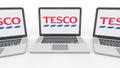 Notebooks with Tesco logo on the screen. Computer technology conceptual editorial 3D rendering Royalty Free Stock Photo