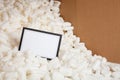 Notecard in packing peanuts with cardboard Royalty Free Stock Photo