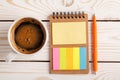 Notepad with bookmarks for documents, pen and a Cup of coffee. Colorful sticky multi-colored stickers. Planning concept Royalty Free Stock Photo