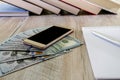 Notepad with books and pen on the table. Dollars, calculator and smartphone. Office concept. Royalty Free Stock Photo