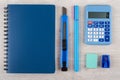 Notepad, calculator and other stationery tools on wooden table Royalty Free Stock Photo