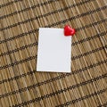 notepad with clip of heart shape with red color on wood background