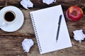 Notepad with coffee cup apple fruit and crumpled paper Royalty Free Stock Photo