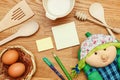 Notepad with cooking utensil on wooden table. Top view.