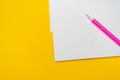 Notepad with copy space with pink pen on yellow background. Simple bright background with place for text Royalty Free Stock Photo