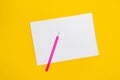 Notepad with copy space with pink pen on yellow background. Simple bright background with place for text Royalty Free Stock Photo