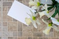 Notepad, daffodils in a vase on a brown table. Inspirational workplace.