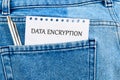 A notepad displaying the term data encryption is tucked inside a denim pocket alongside a silver pen, emphasizing the