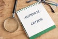 A notepad displays the word authentication, highlighting its importance in security and technology