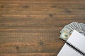 Notepad With Dollar Cash On The Brown Wood Background Royalty Free Stock Photo