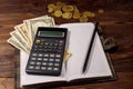 Notepad with dollars, pencil and calculator on wooden desk. Financial planning concept Royalty Free Stock Photo