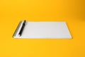 Notepad with erasable pen on yellow background