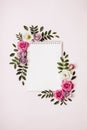 Notepad and floral frame on pink background. Spring Summer concept, boho style