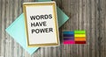 Notepad in a frame with text The words have power lying on a wooden background Royalty Free Stock Photo